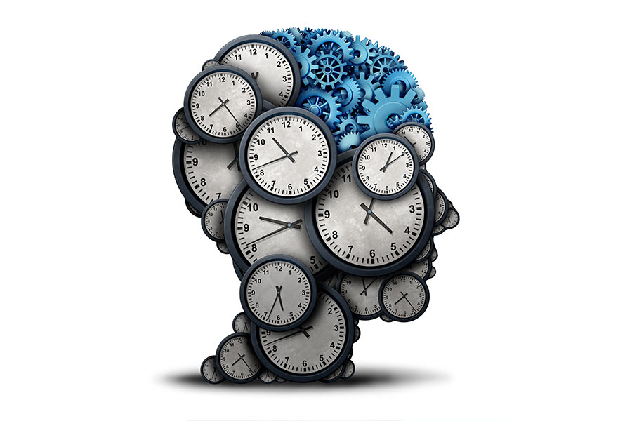 Illustrated time concept as a group of clock objects shaped as a human head with gears and cog wheels as the brain.