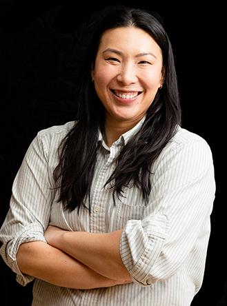 Female scientist poses with her arms crossed. 